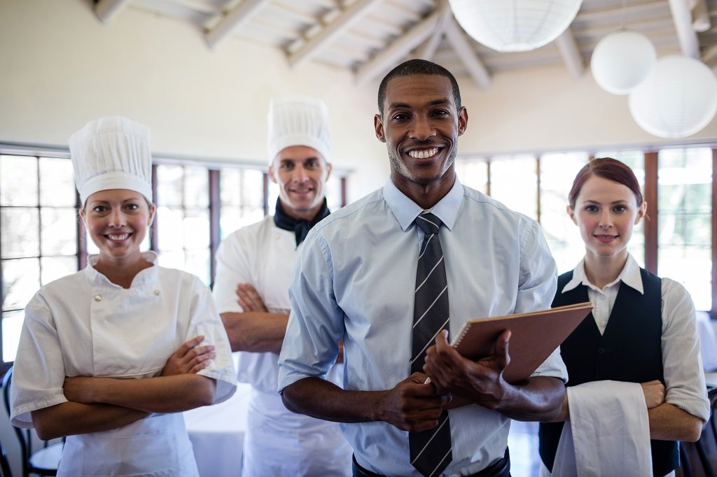 Group Of Happy Hotel Staffs Standing In Hotel Vth4rku